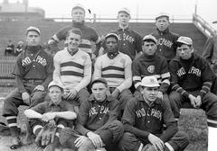 Hyde Park High School baseball team from 1902, eleven young men in uniforms sitting outdoors in Chicago, Illinois with African American player Samuel 'Sam' Ransom in the center