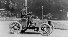 Ettore Bugatti standing beside his Bugatti Type 2 vintage car