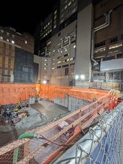Night construction at southeast corner of Bond and Shuter streets with workers and equipment