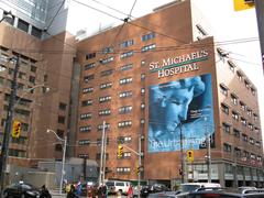 Reflections on St Mike's Hospital building in glass windows