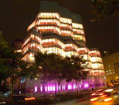 IAC building illuminated at night viewed from bike path across 19th Street and West Side Highway