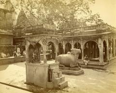 Gyan Vapi well with Nandi statue and Shiva shrine in foreground, Kashi Vishwanath Temple spires in background