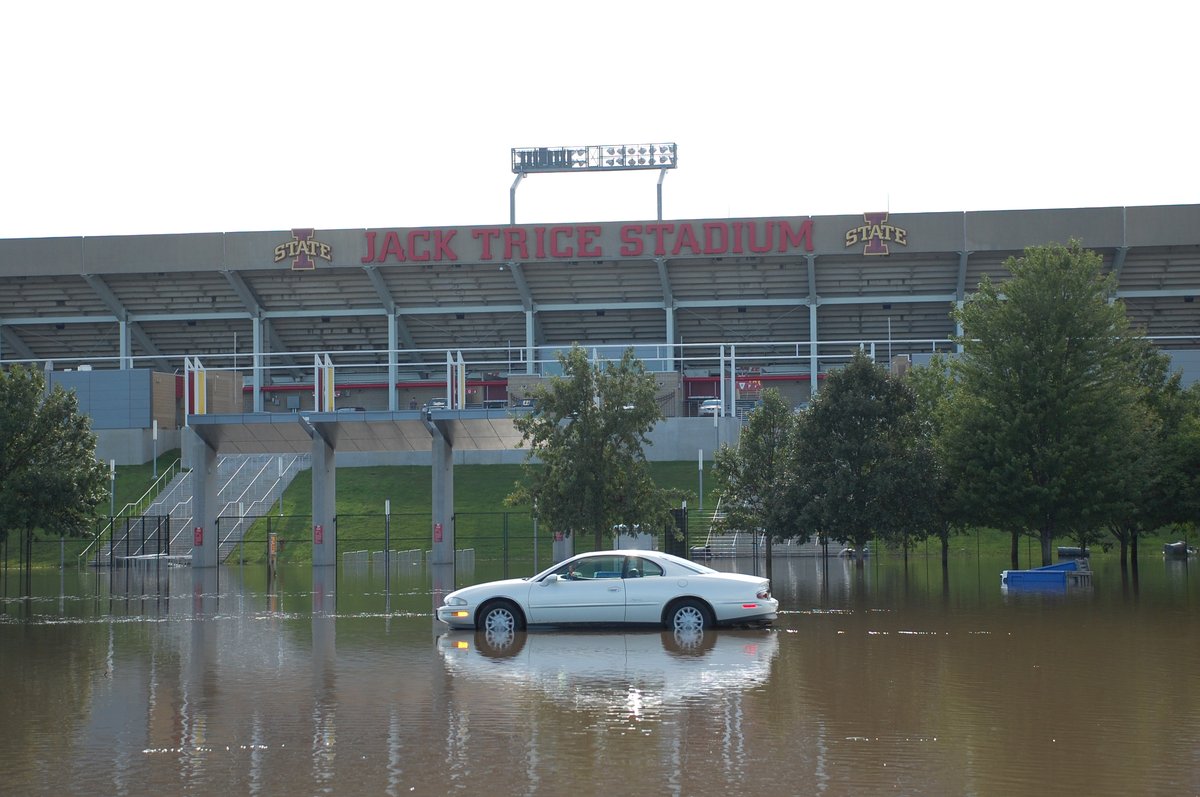 Flooded parking area outside Jack Trice Stadium in Ames Iowa with a lone car