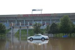 Flooded parking area outside Jack Trice Stadium in Ames Iowa with a lone car