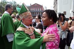 Archbishop Alfred Hughes greeting parishioners at St. Louis Cathedral in New Orleans after Hurricane Katrina evacuation
