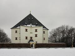 Letohrádek Hvězda Renaissance villa surrounded by snow-covered trees in winter Prague