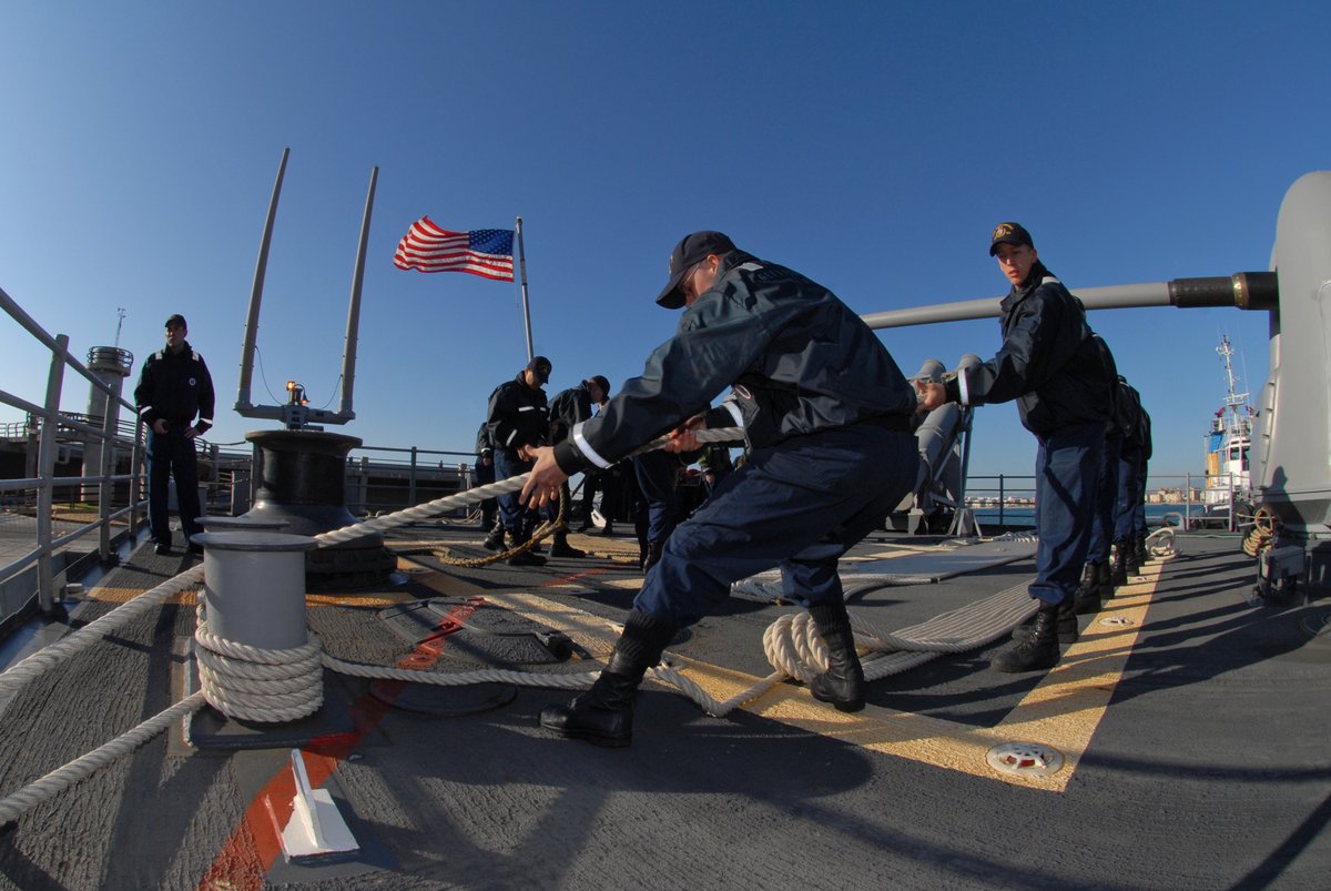 US Gettysburg CG 64 helicopter flies over ship's fantail with USS Wasp crew aboard