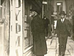 Greek poet Kostis Palamas standing in front of Kauffmann Bookstore in Athens black and white photo