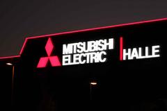 Mitsubishi Electric Halle illuminated sign at night