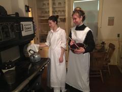 Mary O'Donahue maid of all work and Alice Michelin nursemaid working in a historical kitchen