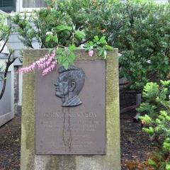 Pink flowers placed on the marker in front of John F. Kennedy's house for his birthday