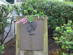 Pink flowers placed on marker in front of John F. Kennedy's house for his birthday