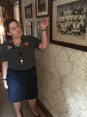 Interpreter pointing to picture while discussing Kennedy family history