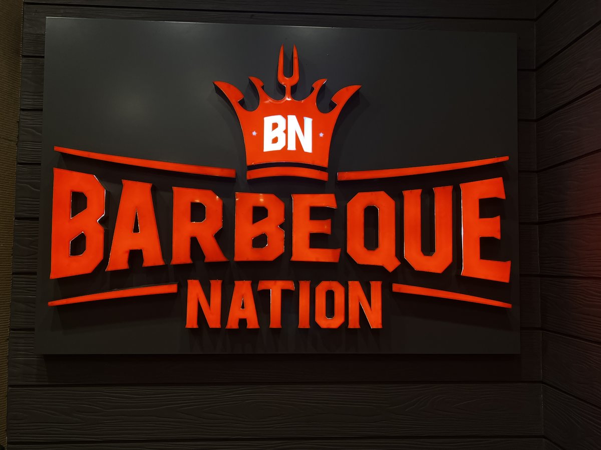 Barbeque Nation Park Street Kolkata restaurant interior with dining tables and red lighting