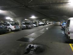 University of Melbourne car park with multiple vehicles and buildings in background