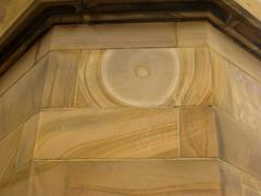 Curvy sandstone rock formation with layers of orange and beige colors