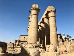 Colonnade of Luxor Temple in Luxor, Egypt with tall columns under blue sky