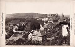 View of Tübingen and surroundings from the east showing Neckar River, Eberhardsbrücke bridge, Platanenallee, Neckarvorstadt, Altstadt with Hohentübingen Castle, and a house on Olgastraße.