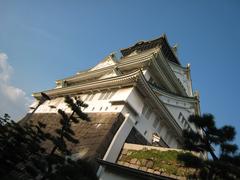 Osaka Castle in Japan with traditional architecture and green trees