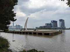 Saigon River flowing through District 1 in Ho Chi Minh City, Vietnam with urban buildings along the riverbank