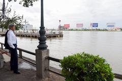 U.S. Secretary of State John Kerry walking through the streets of Ho Chi Minh City looking out at the Saigon River