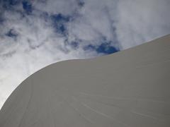 Snow covered volcanic mountain landscape with sand dunes under winter daylight