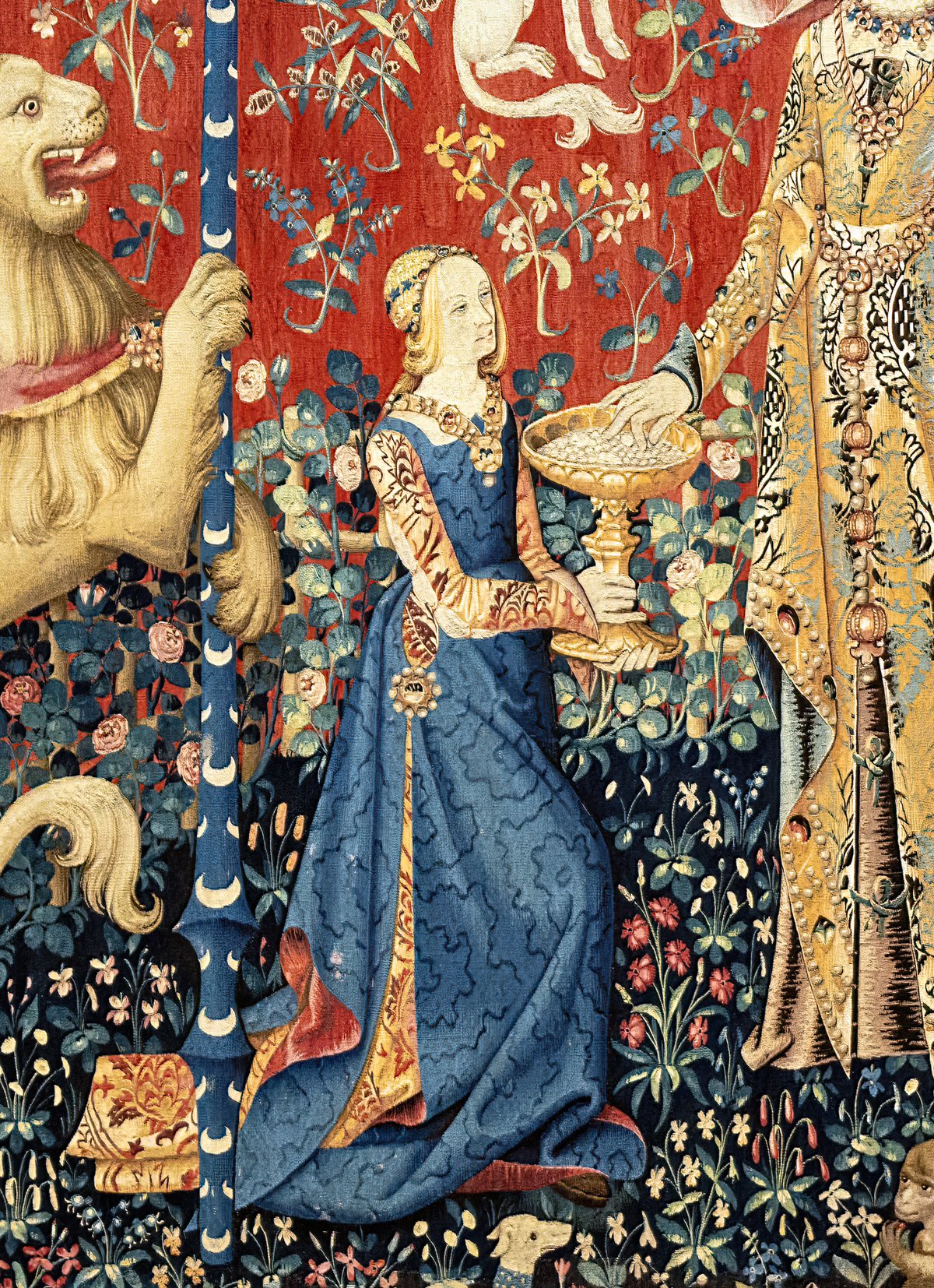 Medieval tapestry panel depicting a standing lady with a unicorn from La Dame à la licorne series at Musée de Cluny, Paris