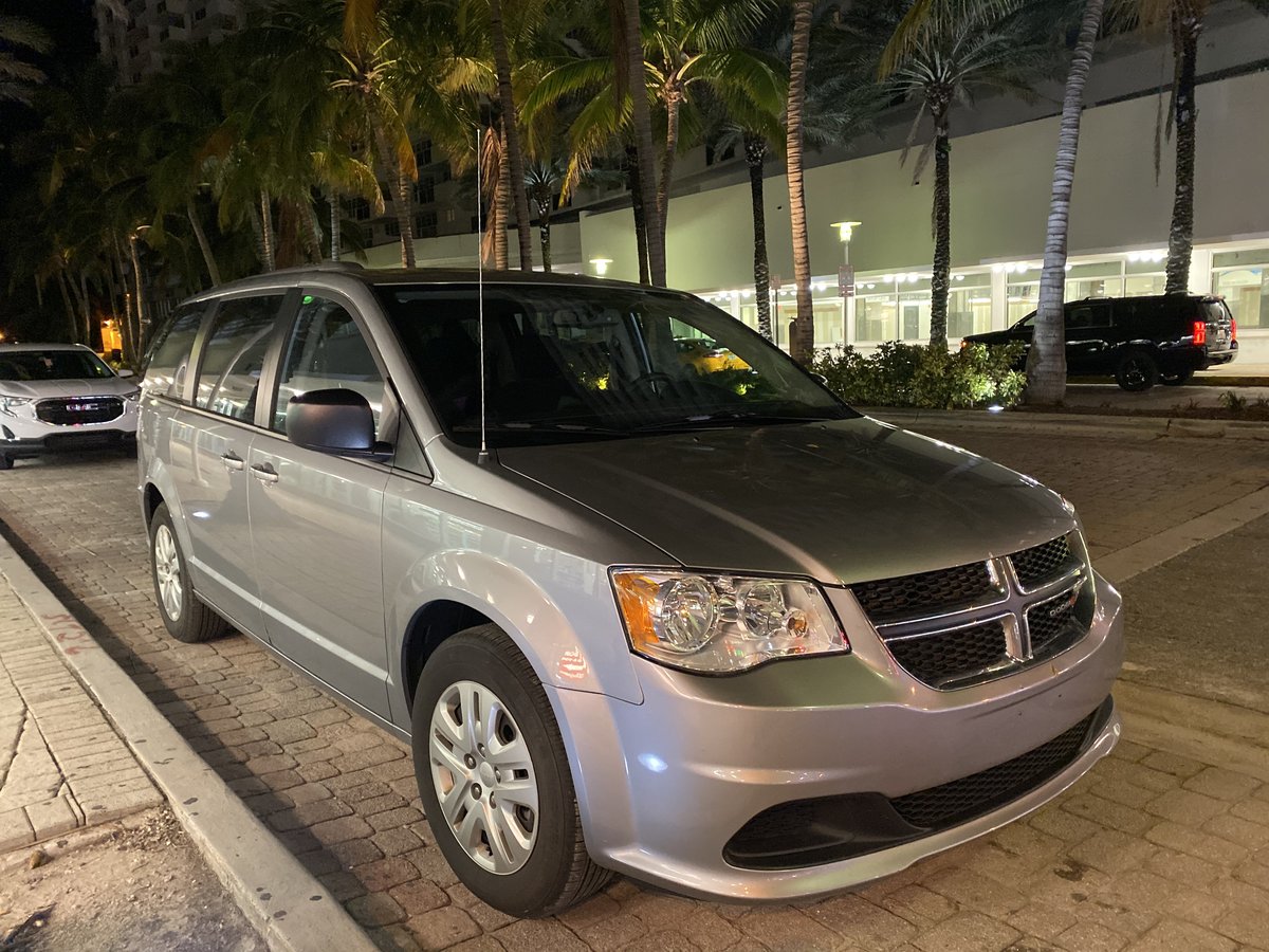 2018 Dodge Grand Caravan RT SE model silver minivan parked on Lincoln Road Miami Beach