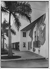 Modernage business at Lincoln and Alton Road in Miami Beach Florida with vintage cars on street