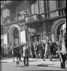 Crowd of men and women queuing for tickets outside the Lyric Theatre on Shaftesbury Avenue, London during wartime August 1943