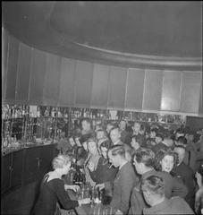 Busy theatre bar scene during interval of 'Flying Colours' at Lyric Theatre London 1943