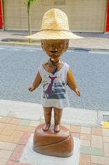 Small figurine of a man standing on a ledge in Kagurazaka, Tokyo, Japan