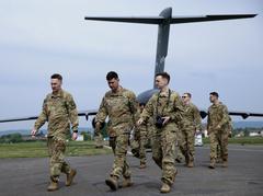 U.S. soldiers loading two HH-60 Medevac Black Hawk helicopters onto a C-17 transport aircraft at Clay Kaserne, Germany for exercise Swift Response 2022
