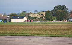 U.S. Army CH-47F Chinook helicopter landing at Wiesbaden Army Airfield with 12 CAB leaders event in background