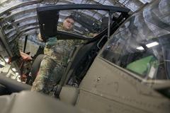 Two AH-64D Longbow helicopters being loaded onto a U.S. Air Force C-17 transport aircraft by soldiers at Wiesbaden Army Airfield