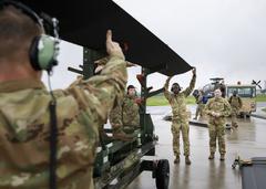 Soldiers preparing to load two AH-64D Longbow helicopters onto a US Air Force C-17 transport aircraft at Wiesbaden Army Airfield