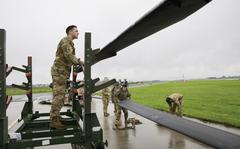 Soldiers loading AH-64D Longbow helicopters onto C-17 transport aircraft at Wiesbaden Army Airfield