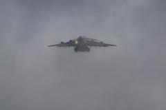 U.S. Air Force C-17 transport aircraft landing at Wiesbaden Army Airfield with soldiers loading AH-64D Longbow and AH-64E Apache Guardian helicopters