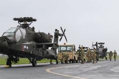 Soldiers loading AH-64D Longbow helicopters onto C-17 aircraft at Wiesbaden Army Airfield