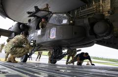 Soldiers from 1st Battalion, 3rd Aviation Regiment loading AH-64D Longbow helicopters onto a U.S. Air Force C-17 transport aircraft at Wiesbaden Army Airfield, Germany
