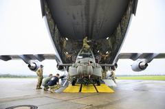 Soldiers of 12th Combat Aviation Brigade loading AH-64D Longbow helicopters onto a C-17 transport aircraft at Wiesbaden Army Airfield in Germany