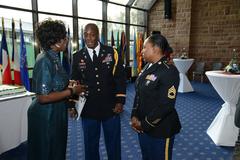 Dianne Crawford talks with Capt. Johnson and Sfc. Rivera at Multi National 2013 New Year's reception on Clay Kaserne in Wiesbaden, Germany