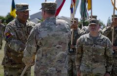 U.S. Army Gen. Darryl Williams accepting guidon from Gen. Tod D. Wolters during change of command ceremony at Clay Kaserne Wiesbaden Germany June 28 2022