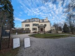Front view of Spadina House with a brick exterior and green lawn in December 2023