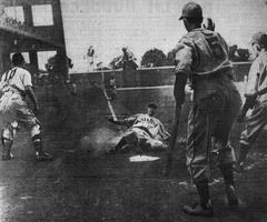 Seattle Rainiers baseball player Al Niemiec sliding into home plate at Wrigley Field in 1942
