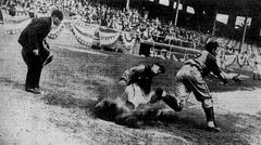 Pete Mallory sliding safely into home plate during baseball game