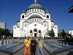 Three men representing brotherhood of Yugoslav nations and Christian unity in front of largest Balkan Christian church