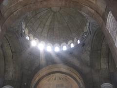Sunbeams shining through the openings of an unfinished dome