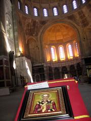 Orthodox believers kissing Saint Sava icon and giving alms during church construction