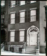 Entrance doorway of Tredwell House Old Merchant's House in Manhattan with shuttered windows, ionic columns and ornate woodwork